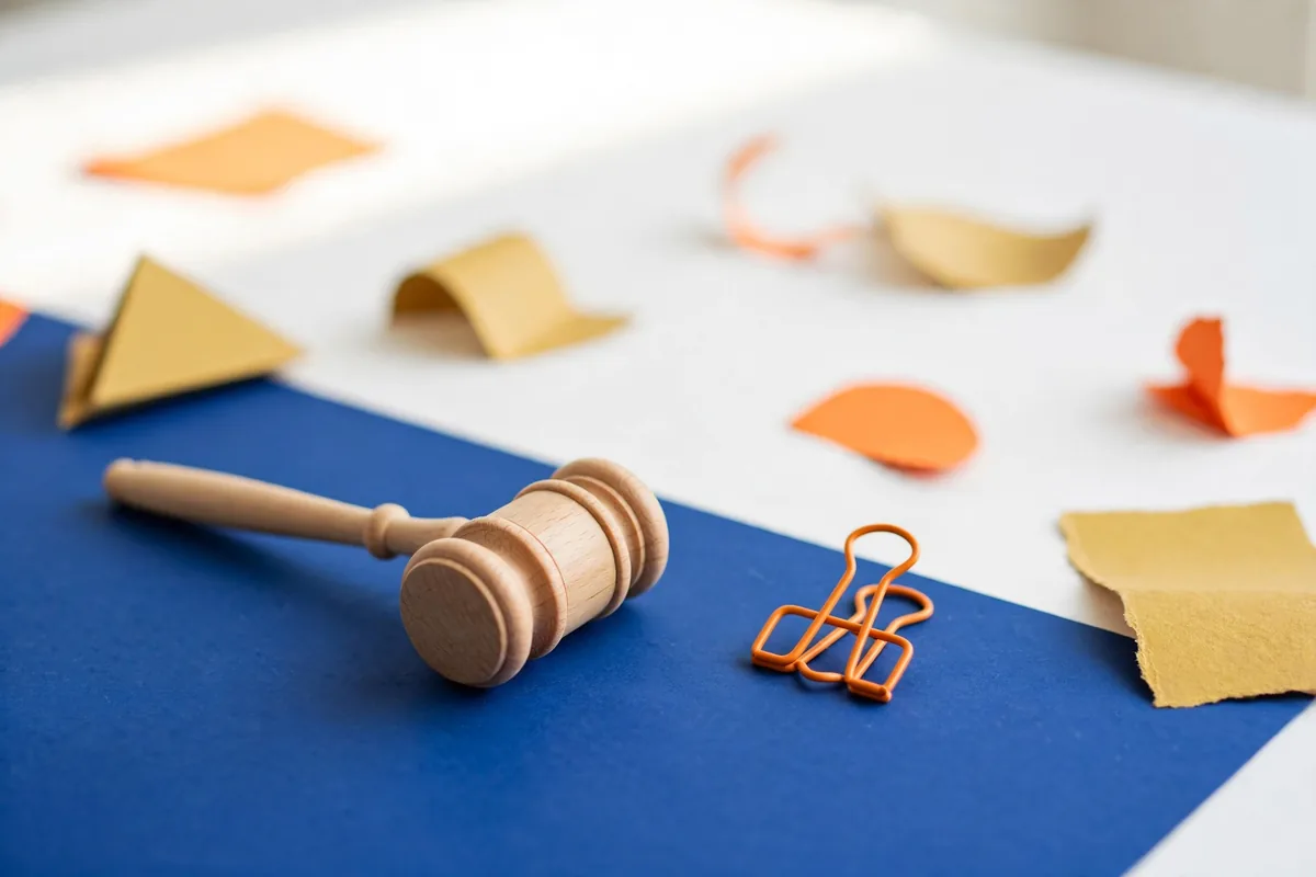 A wooden gavel on a blue desk
